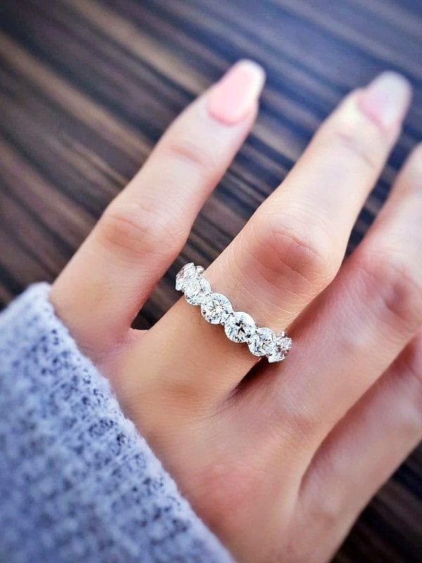 a woman's hand with a diamond ring on it