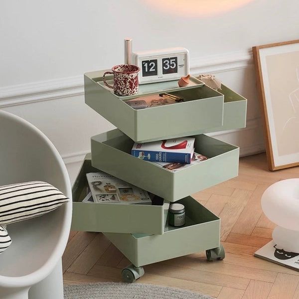 a table with three drawers on it in a room next to a chair and lamp