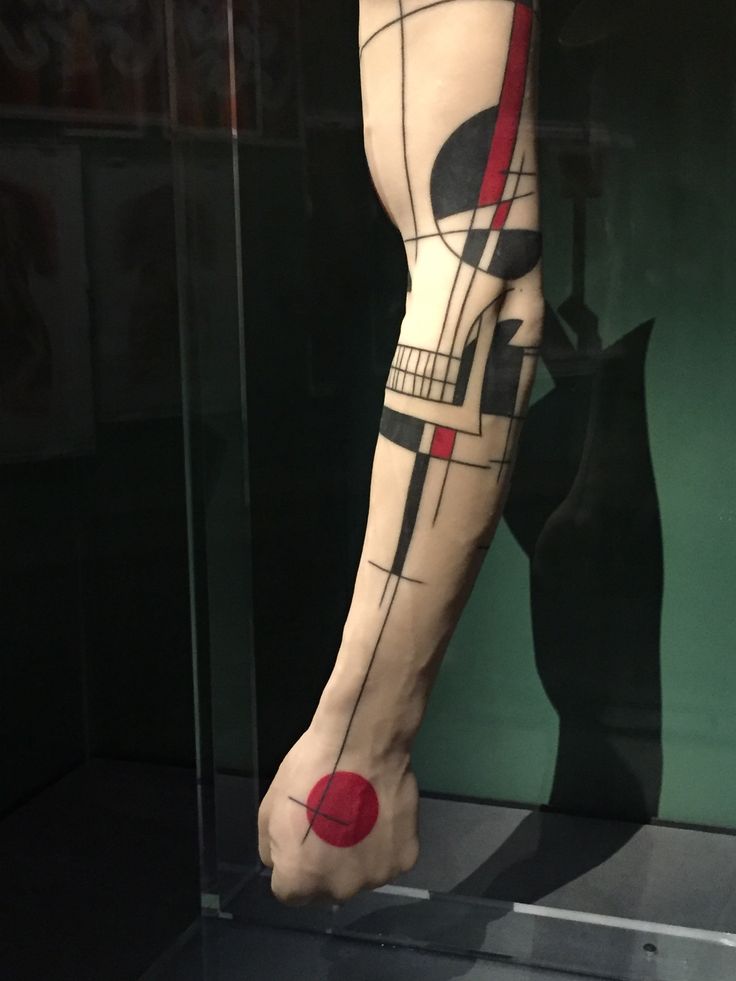 a person's leg with a tattoo on it in a display case at a museum