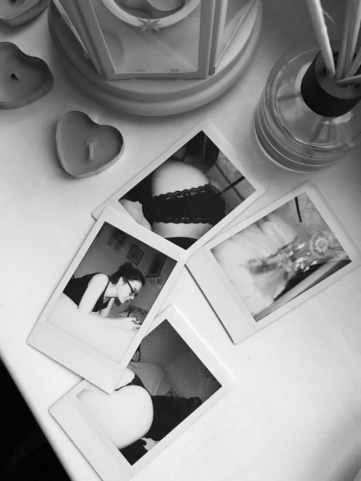 three polaroid photos sitting on top of a white table next to candles and vases