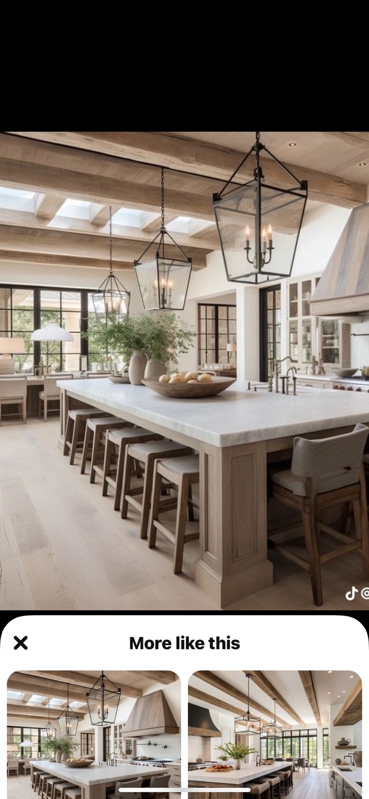 an open concept kitchen and dining room with large island in front of the countertop