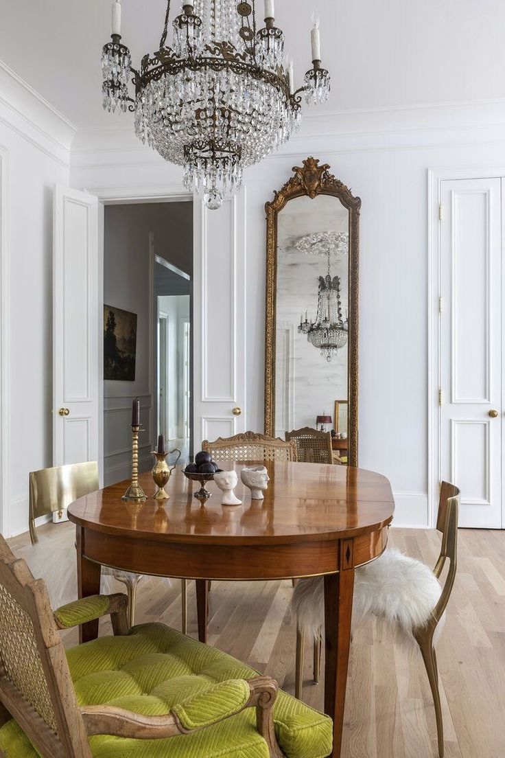 a dining room table with chairs and a chandelier