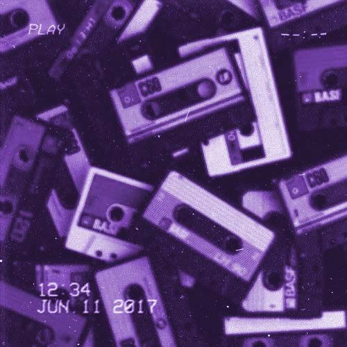 a pile of cassettes sitting next to each other on top of a purple background