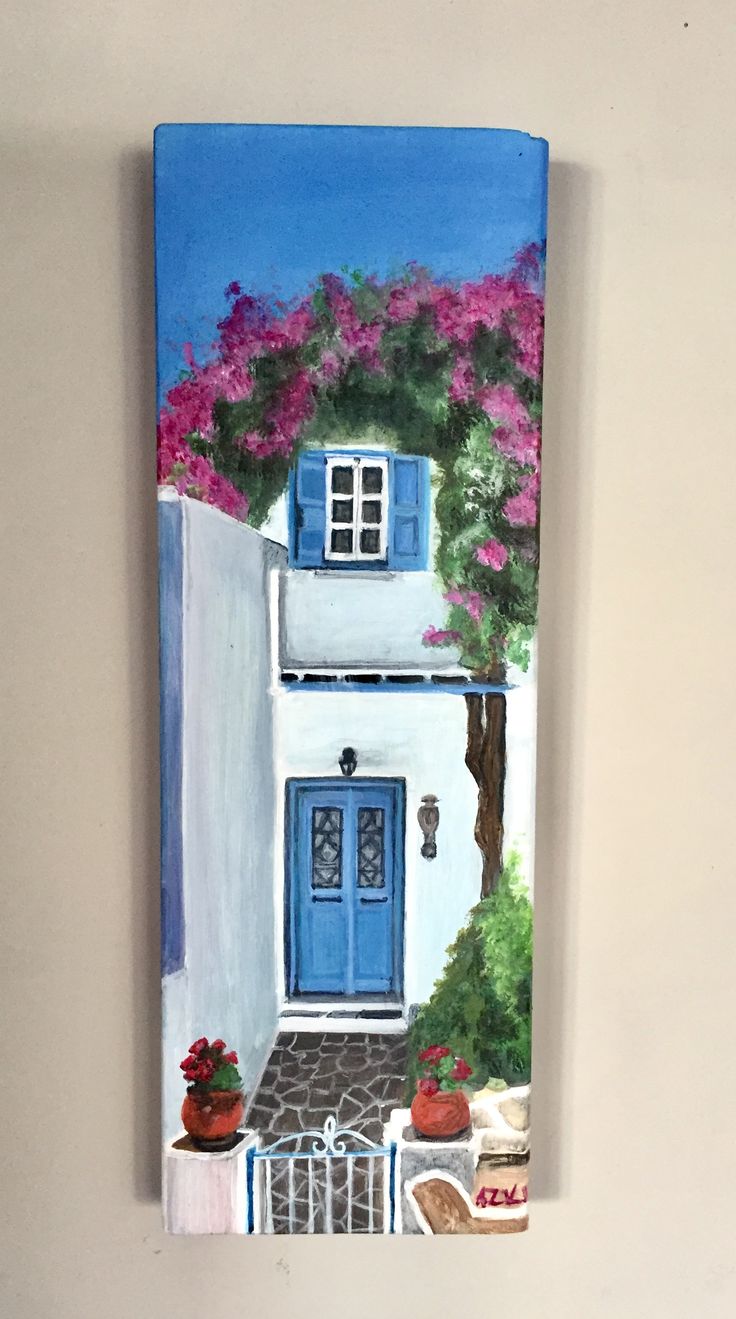 a painting of a house with blue doors and pink flowers on the front door is hanging on a wall