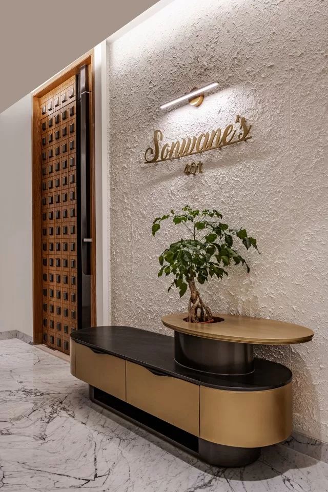 a plant is sitting on top of a table in front of the entrance to a building