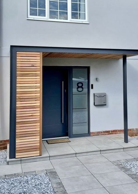 an entrance to a modern building with wooden slats on the door and side walls