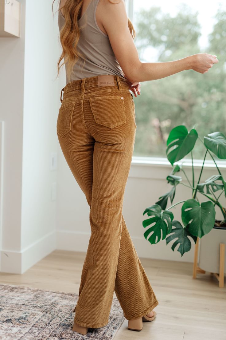 Our Cordelia Bootcut Corduroy Pants from Judy Blue make a stylish and comfortable addition to your wardrobe. With a classic corduroy feel, mid-rise, bootcut fit, and rich camel color, you'll be sure to look and feel your best. Judy Blue Mid Rise Zip Fly Minimal to No Stretch Bootcut Silhouette Slit Hem 98% Cotton, 2%Spandex Runs Small, Size Up 0/24: Waist 26" Hips 34" Rise 9" Inseam 32.5"1/25: Waist 28" Hips 35" Rise 9.5" Inseam 32.5"3/26: Waist 29" Hips 36" Rise 9.5" Inseam 32.5"5/27: Waist 30" Womens Corduroy Pants, Women's Pants, Casual Non-stretch Corduroy Bottoms, Fitted Mid-rise Corduroy Pants, Blue High-waist Corduroy Bottoms, Fitted Full-length Corduroy Pants, Stretch Full-length Corduroy Pants, Camel Color, Judy Blue Jeans