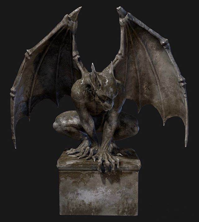 a statue of a gargoyle sitting on top of a stone block with its wings spread