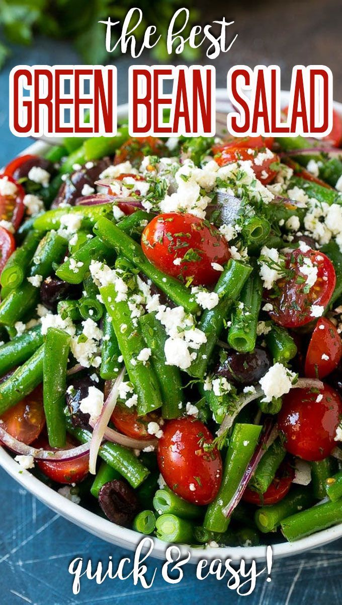 the best green bean salad with feta cheese and tomatoes in a white bowl on a blue table