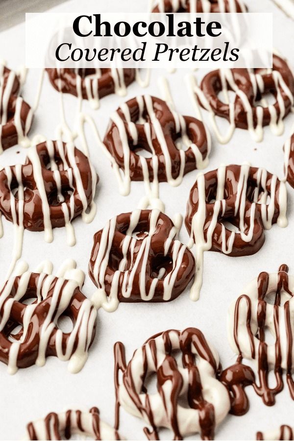 chocolate covered pretzels on a baking sheet with white icing and drizzle