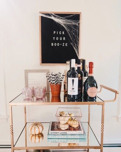 a bar cart filled with wine bottles and donuts