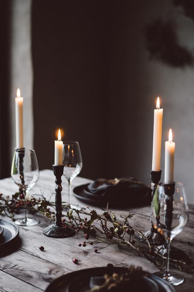 the table is set with candles and place settings