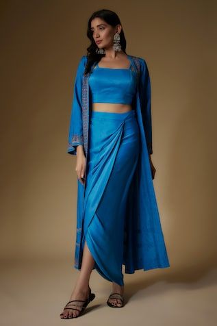 Blue long jacket featuring print detailing hem. Paired with solid bustier and a draped skirt. - Aza Fashions Festive Fitted Silk Draped Skirt, Fitted Draped Sets For Spring, Elegant Draped Blue Sets, Elegant Blue Draped Sets, Chic Fitted Set With Traditional Drape, Chic Fitted Sets With Traditional Drape, Fitted Sets With Draped Sleeves, Fitted Draped Skirt For Festive Occasions, Elegant Fitted Side Open Dress