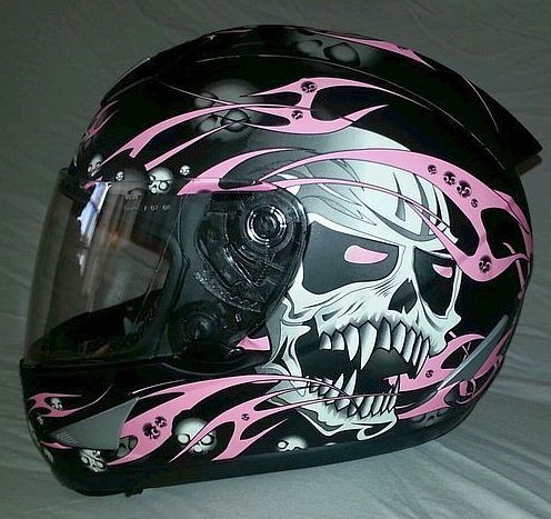 a helmet with a skull painted on the side and pink flames coming out of it