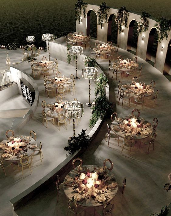 an aerial view of tables and chairs in a circular area with lights on the floor