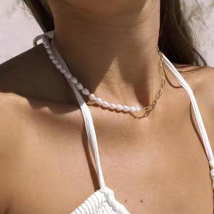 Add a touch of elegance and edge to your outfit with our Pearl & Chain Necklace. The lustrous pearls paired with a bold chain create a unique and sophisticated look. Perfect for any occasion. Chic White Beaded Necklace, Chic White Clavicle Chain Necklace, Elegant Pearl White Beaded Chain Necklace, Chic White Necklace With Clavicle Chain, Elegant Pearl White Necklace With Beaded Chain, Trendy Pearl Necklace Chain Gift, Trendy Pearl Necklace As A Gift, Trendy Pearl Necklace For Gift, Feminine Party Chain Jewelry