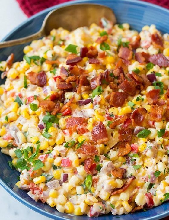 a blue bowl filled with corn and bacon