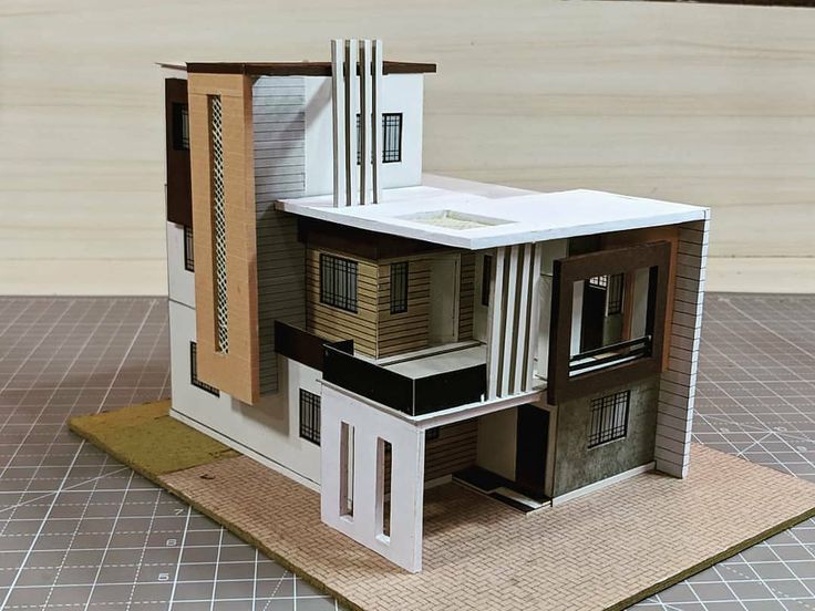 a paper model of a house sitting on top of a table