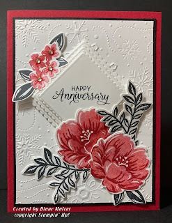 an anniversary card with red flowers and white lace on the edge, in front of a black background