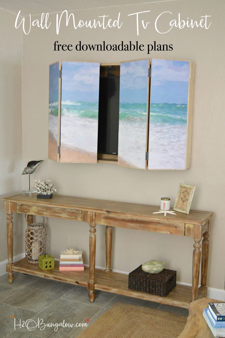 a living room with two paintings on the wall and a table in front of it