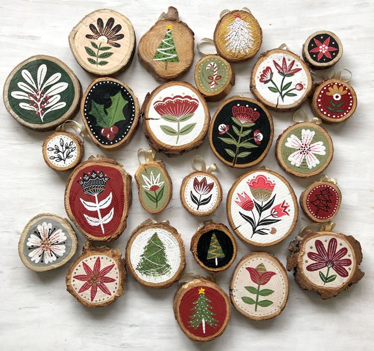 a collection of embroidered christmas ornaments on wooden slices with flowers and trees in them, all handmade