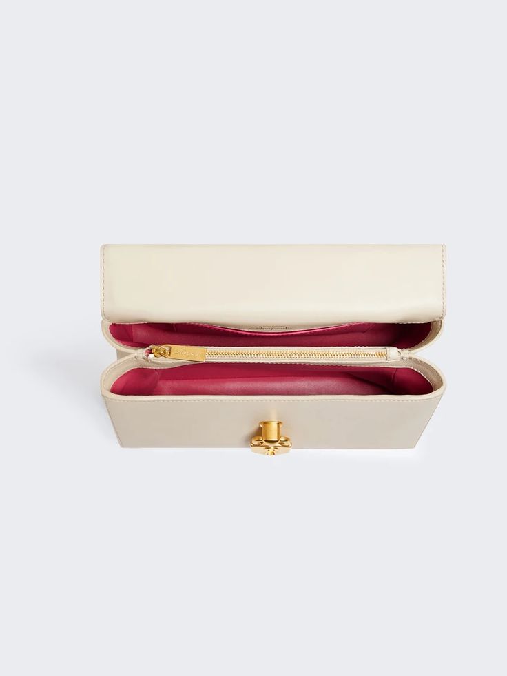 [vc_row][vc_column width=”1/3″][vc_column_text text_larger=”no”] Schiaparelli Schiaparelli Secret Bag A bag crafted from smooth ecru lambskin. It is secured with a gilded brass toggle clasp in the form of a Padlock with black enamel detailing.   The bag is carried by hand with a top handle fastened with gilded brass fasteners.   Removable leather shoulder strap.   Height 17,5cm, Width 24,5cm, Depth 6cm. Schiaparelli Secret Bag has been a staple of the fashion world for de Rectangular Satchel With Dust Bag, Designer Rectangular Baguette Bag With Detachable Handle, Designer Beige Rectangular Case Bag, Luxury Rectangular Clutch For Shopping, Elegant Rectangular Satchel For Shopping, Rectangular Shopping Bag With Detachable Strap, Daily Use Bags With Gold-tone Hardware And Rectangular Case, Rectangular Case Bag With Gold-tone Hardware For Daily Use, Designer Rectangular Case Clutch For Shopping