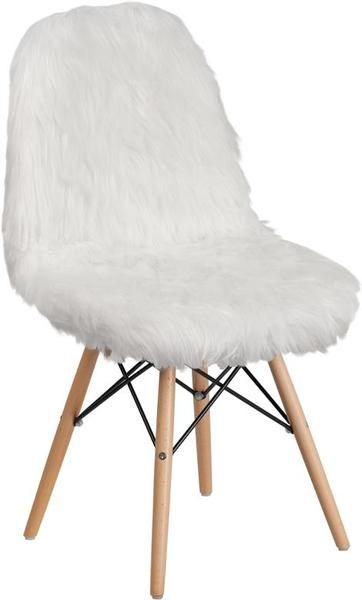 a white chair with wooden legs and fur on it