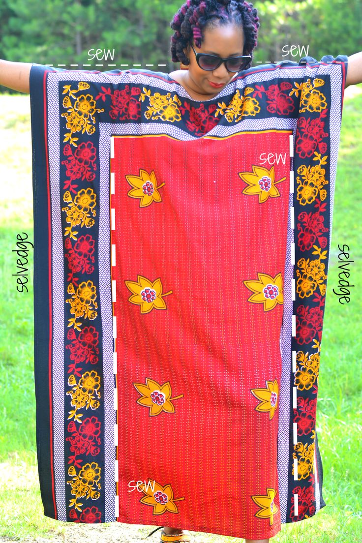 a woman is holding up a colorful blanket