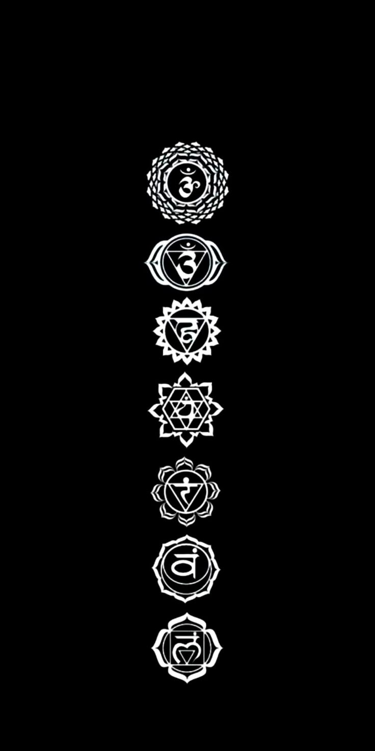 seven chakras are arranged in the shape of a flower on a black background