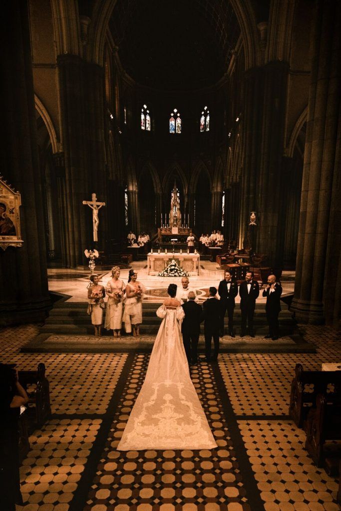 the bride and groom are getting married in front of the alter at st patrick's cathedral