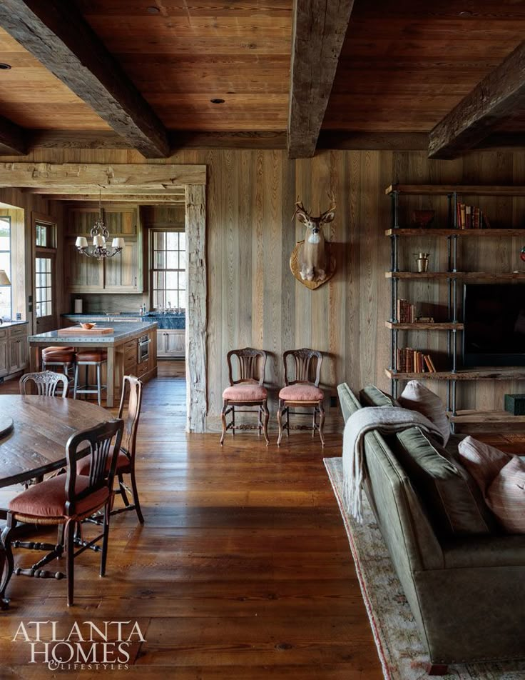 the inside of a house with wooden walls and wood flooring is featured in this image