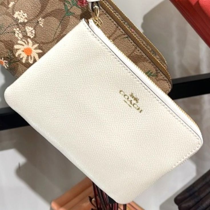 Coach Corner Zip Wristlet Chalk Leather Color: Gold / Chalk Signature Coated Canvas With Crossgrain Gold Logo Two Credit Card Slots Zip-Top Closure, Fabric Lining Wrist Strap Attached 6 1/4" (L) X 4" (H) X 1/2" (W) Chic White Coin Purse For Everyday Use, Chic White Wallet For Everyday Use, Chic White Wallets For Everyday Use, White Coin Purse With Removable Pouch For Everyday Use, White Pouch Wallet For Everyday Use, White Clutch With Zipper Pouch For Everyday, White Clutch Pouch For Formal Occasions, Elegant White Clutch For Everyday Use, White Clutch Wallet As Gift