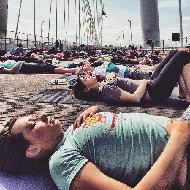 many people are laying on their stomachs and doing yoga