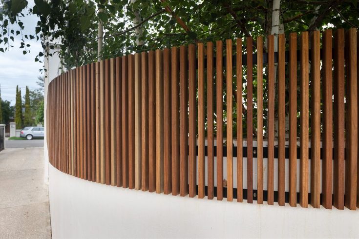 a wooden fence on the side of a road