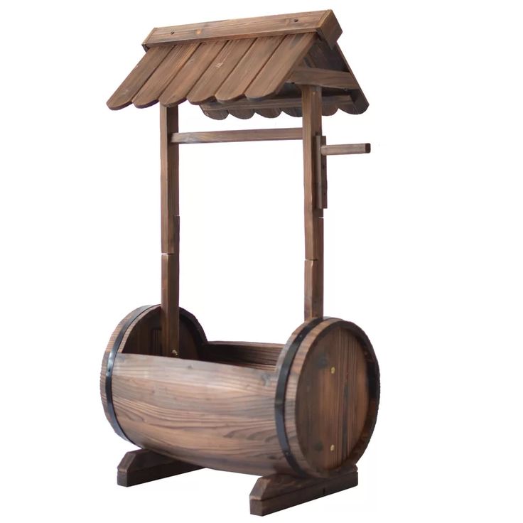 a wooden water well with a roof on it's top and wheels attached to the side