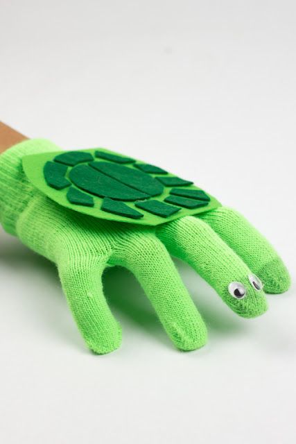 a hand that has a green turtle on it