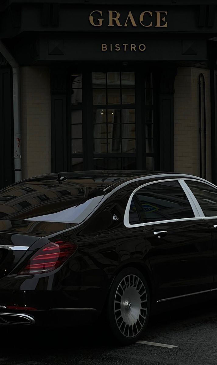 a black car parked in front of a building with the name grace bistro on it