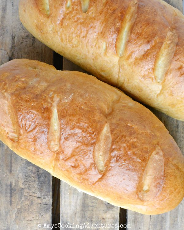 two loaves of bread sitting on top of a wooden table