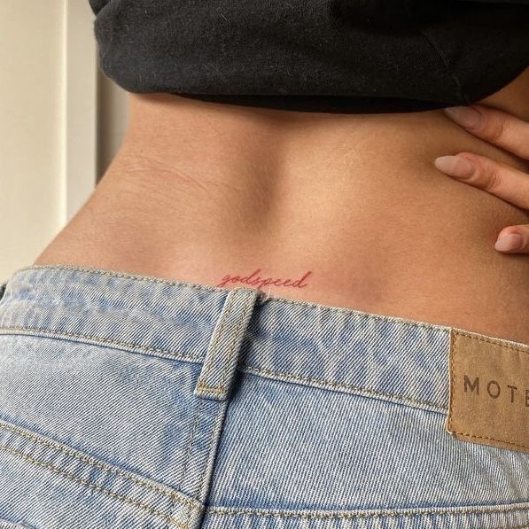 a woman's stomach with the word mother tattooed on her lower back and bottom