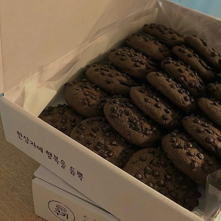 a box filled with chocolate cookies sitting on top of a wooden table