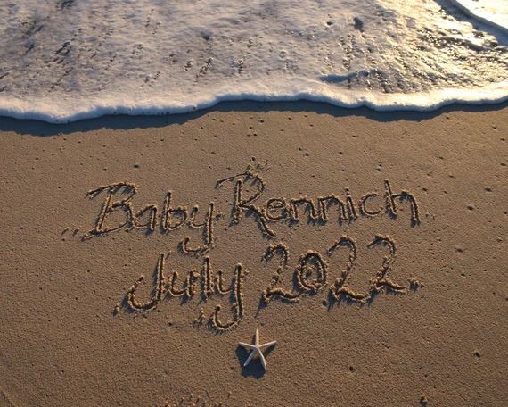 a starfish is writing in the sand next to the ocean and beach with its name written on it