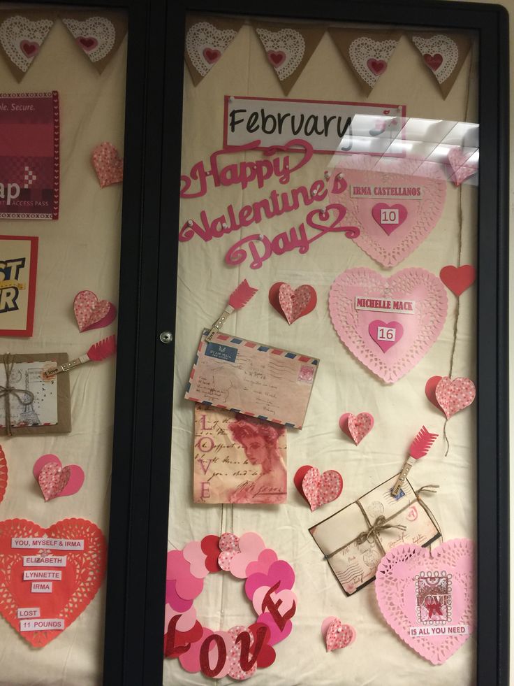 valentine's day bulletin board with pink and red hearts hanging on the front door