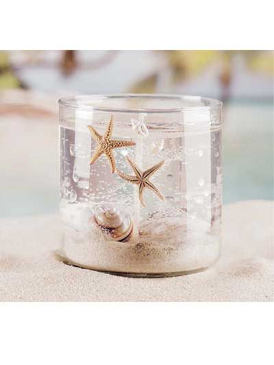 a glass jar filled with sand and starfish