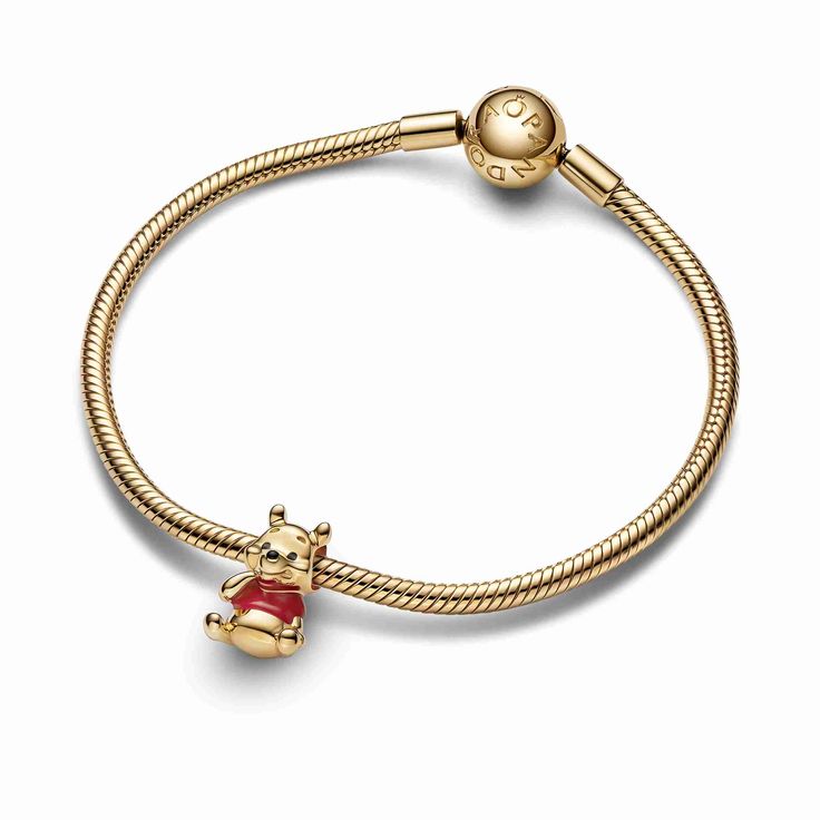 Time for something sweet! The 14k gold-plated Disney's Winnie the Pooh Bear Charm features the much-loved Winnie the Pooh character in a seated pose with his paw raised ready to eat some delicious honey. The lovable bear wears a T-shirt colored with red enamel, and black enamel details bring his cheerful expression to life. Add Winnie the Pooh and friends to your bracelet or charm holder and reignite your favorite memories of moments spent with friends. Disney Pandora Bracelet, Winnie The Pooh Character, Winnie The Pooh Decor, Charms Disney, Cheerful Expression, Pandora Bracelet Charms Ideas, Pandora Charms Disney, Winnie The Pooh And Friends, Pooh And Friends