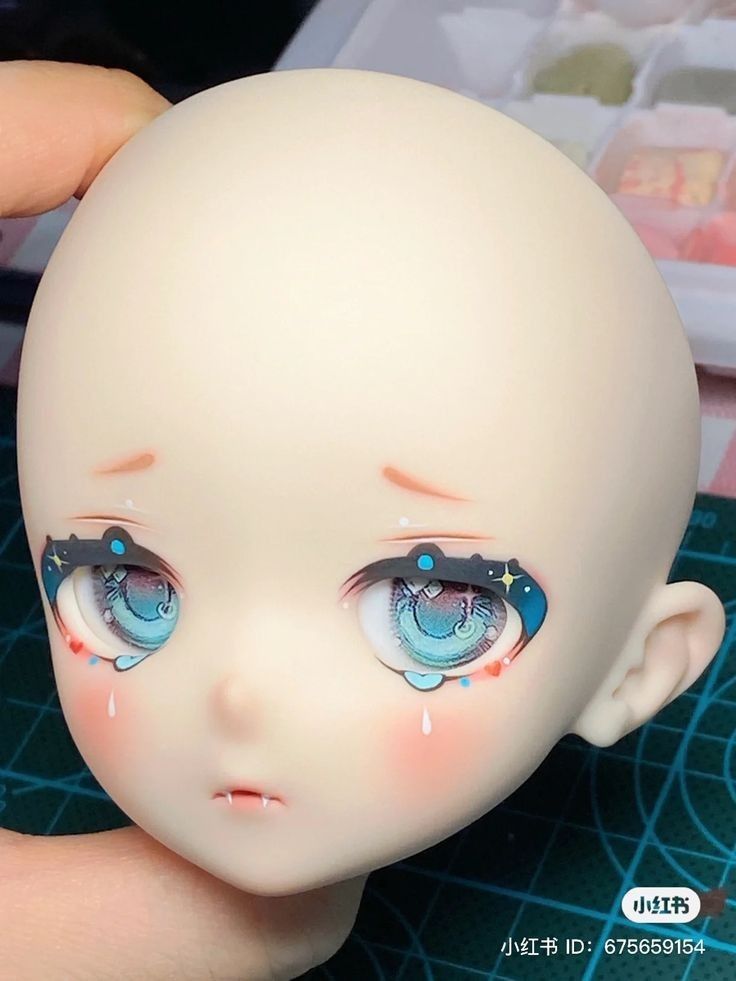 a close up of a doll's face with blue eyes