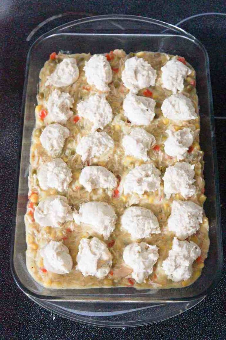 a casserole dish filled with lots of cheese on top of black countertop