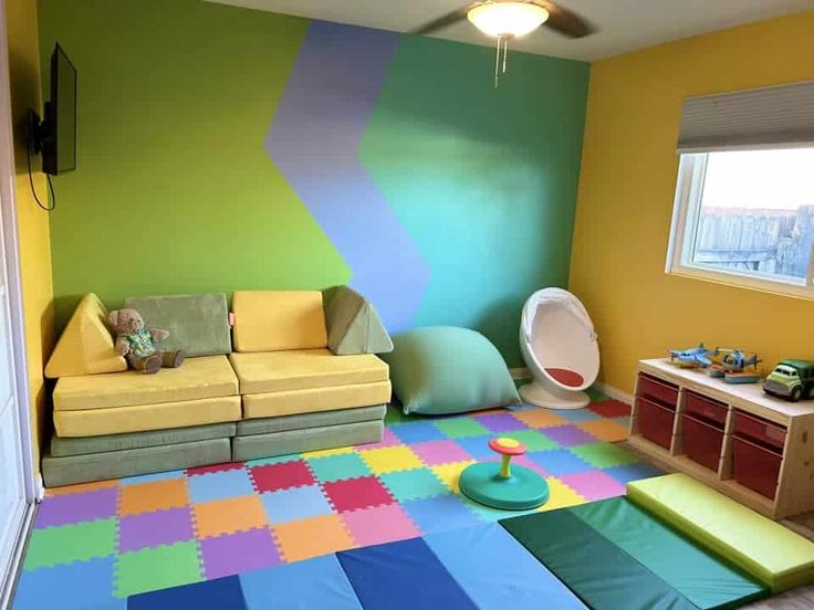 a child's playroom with multicolored rugs and furniture