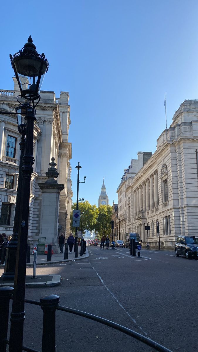 an empty city street with cars parked on the side