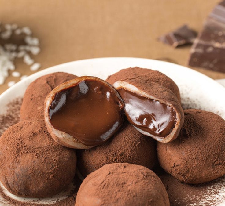 some chocolate desserts are on a white plate