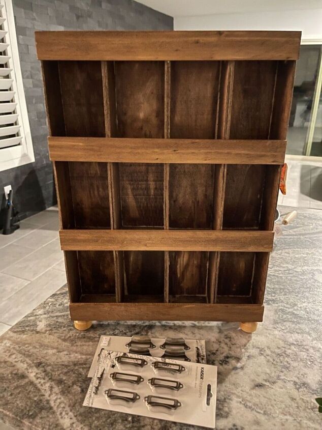 a wooden book case sitting on top of a counter next to a knife holder with knives in it